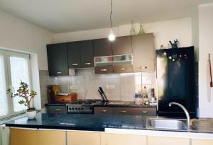 a kitchen with a black refrigerator and a sink at Guesthouse 2207 in Sremski Karlovci +8 photos