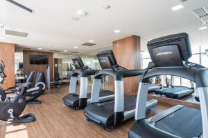 a gym with several treadmills and cardio machines at Windsor Marapendi Hotel in Rio de Janeiro