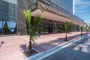 two palm trees in front of a building at Windsor Marapendi Hotel in Rio de Janeiro