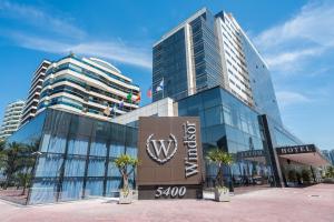 a hotel with a sign in front of a building at Windsor Marapendi Hotel in Rio de Janeiro