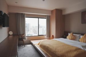 Postel nebo postele na pokoji v ubytování ICHIYU HOTEL ASAKUSA