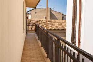a corridor of a building with a balcony at Appartamenti ABR Corso in Le Castella