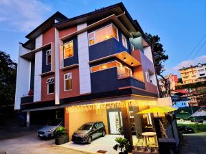 a building with a car parked in front of it at #3 Baguio City I Service Apartment I Deutsches Guesthouse & Homestay Baguio I Walking distance to Lourdes Grotto and nearby tourist attractions in Baguio