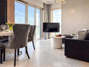 a living room with a table and a couch at URBAN APARTMENTS GLOBAL SKYLINE, 15th Floor No 23, Free Garage, Self Check-in, No Deposit in Katowice
