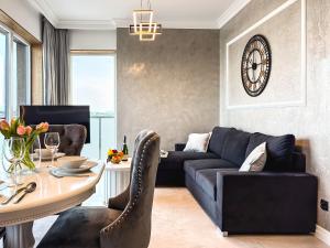 a living room with a couch and a table at URBAN APARTMENTS GLOBAL SKYLINE, 15th Floor No 23, Free Garage, Self Check-in, No Deposit in Katowice +28 photos