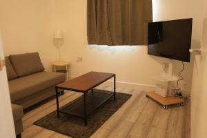 a living room with a couch and a table at Cosy Getaway near beach in Southend-on-Sea