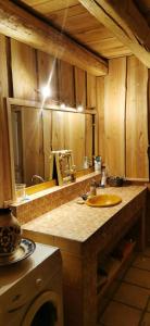 a kitchen counter with a sink and a mirror at Maison de charme à la Salvetat-sur-Agout 3 chambres in La Salvetat +17 photos
