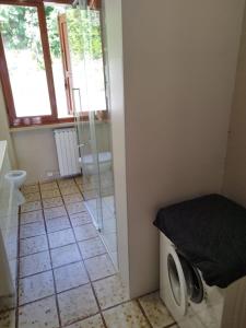 a bathroom with a washing machine and a window at Peaceful Lakefront in Marone +30 photos