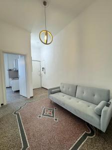 a living room with a couch and a table at Savona Casa Centro vicino Mare in Savona +14 photos