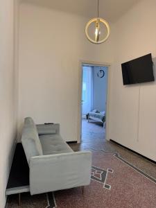 a living room with a couch and a flat screen tv at Savona Casa Centro vicino Mare in Savona