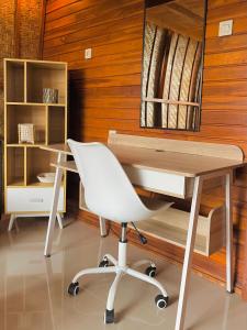 a white desk and a white chair in a room at Murna House 2, Rooftop Balinese Wooden House 360 sunrise to sunset view in Uluwatu
