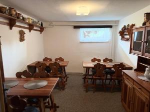 a classroom with tables and chairs in a room at Pension Burger in Harrachov