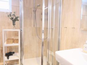 a shower with a glass door in a bathroom at Ostertresker 78, DHH in Tinnum +18 photos