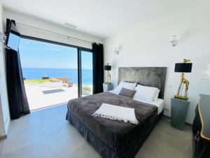 a bedroom with a bed with a view of the ocean at Villa prestige au bord de l'eau- Pietracorbara in Pietracorbara +31 photos