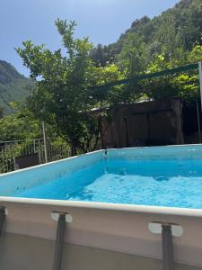 a hot tub with a mountain in the background at La Perla del Mare Apartment Vietri sul Mare in Albori