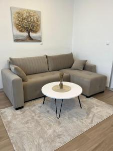 a living room with a couch and a table at Apartmani Marić in Gornji Vakuf