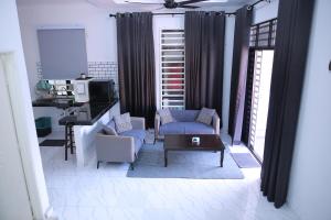 a living room with a couch and a table and chairs at Green Dream Homestay 3 Kota Bharu 3 Aircond Room With Wifi & Netflix in Kota Bharu