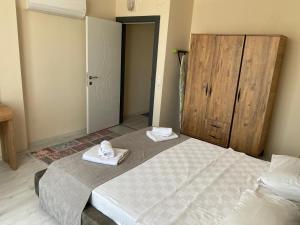 a bedroom with a large bed with towels on it at Atlas Apart Demre in Antalya +3 photos