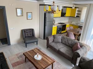 a living room with a couch and a table at Atlas Apart Demre in Zumrutkaya