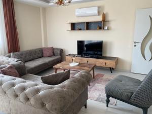 a living room with a couch and a coffee table at Atlas Apart Demre in Zumrutkaya