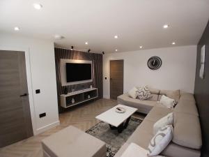 a living room with a couch and a tv at Newly renovated house Elgin in Elgin
