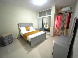 a bedroom with a large bed and a window at Balcon Skyline 2 in Jarabacoa