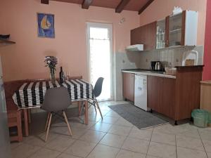 a kitchen with a table and chairs and a table and a table and a kitchen at Apartments vila Vanda in Poreč