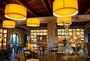 a restaurant with a large glass vase and tables and chairs at Agriturismo Tenuta Lagala in Venosa