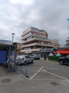 a parking lot with cars parked in front of a building at Nice studio 5 minutes walk from the beach in Cagnes-sur-Mer