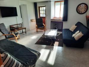 a living room with a couch and a coffee table at l'Escapade Charentaise in Mons