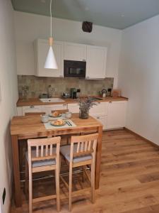 a kitchen with a wooden table with chairs and a tableasteryasteryasteryasteryastery at Palazzo Bottino in Bolsena