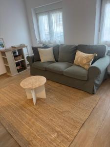 a living room with a couch and a coffee table at Apartamento La Sabina in Reinosa