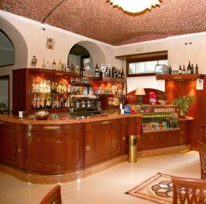 a bar in a restaurant with a lot of alcohol at Hotel Nizza in Turin