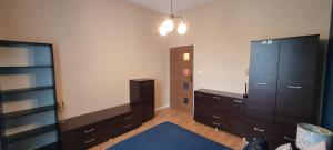 a room with a bedroom with dressers and a closet at Apartament Magnolia in Nysa
