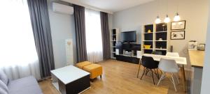 a small living room with a table and chairs at Apartament Magnolia in Nysa