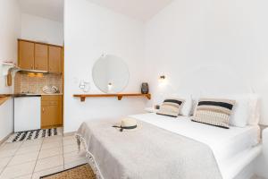 a bedroom with two beds and a mirror at Anastasia Aegean View in Agios Prokopios