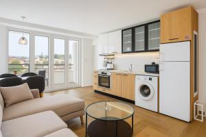 a kitchen and living room with a couch and a table at South Panoramic Apartment in the art district of Kapana in Plovdiv