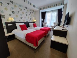 Postel nebo postele na pokoji v ubytování East Gate Boutique Hotel