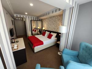 a hotel room with a bed and a chair at East Gate Boutique Hotel in Tbilisi City