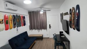 a living room with surfboards on the wall at Rub-a-Dub in Santos