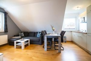 a living room with a couch and a table at Ferienwohnung Schröder-Ehrke in Breege