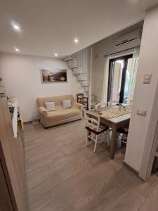 a living room with a couch and a table at Villa Vera Tropea - free parking in Tropea