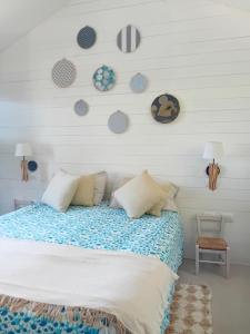 a bedroom with a bed with plates on the wall at Ama(A’ in Fano