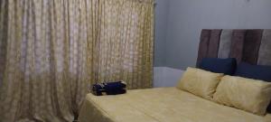 a bedroom with a bed with a curtain and a bed sidx sidx sidx at Green Escape Cottage Guesthouse in Albert Falls