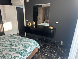 a bedroom with a bed and a dresser with a mirror at Belek Room Voyage in Belek +3 photos