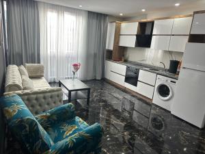 a living room with a couch and a kitchen at Belek Room Voyage in Belek