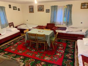 a living room with a table and a couch at Domacinstvo Obradovic Nadgora in Nadgora +18 photos