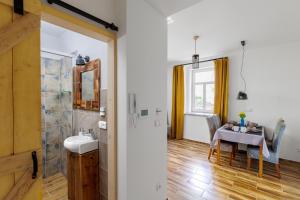 a bathroom with a table and a dining room at Bob Apartmá - Resort Abertham in Abertamy