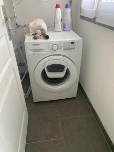 a white washing machine in a kitchen with a counter at La longère de Paul et Suzanne in Pendé +3 photos