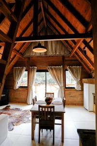 a dining room with a table and chairs at Pousada Encanto Verde in Bom Jardim da Serra